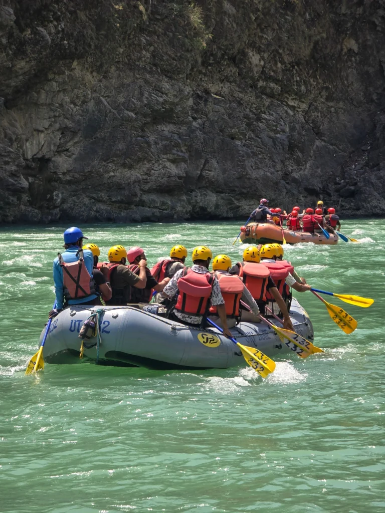Tourists enjoying river rafting in Rishikesh on the Ganga River